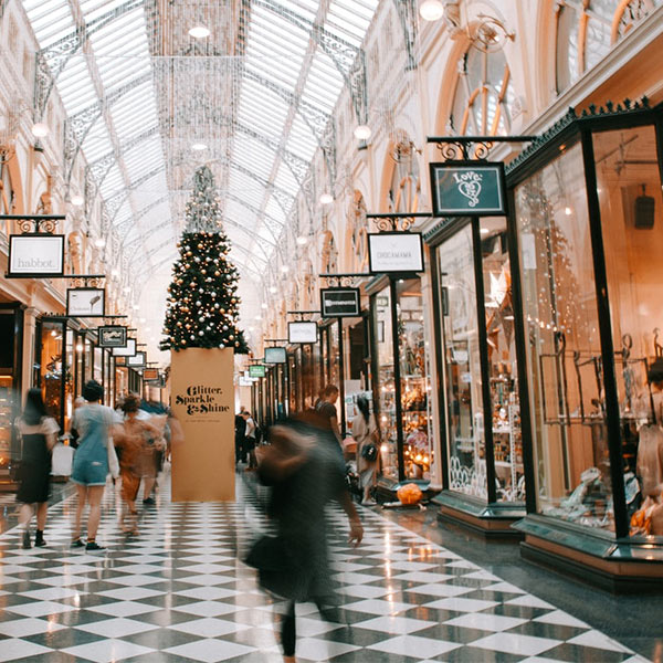 A shopping mall with checkered floors is decorated for Christmas
