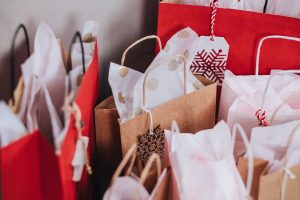 Red and brown gift bags stuffed with tissue paper
