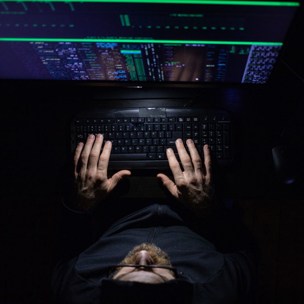 Hacker working at computer terminal